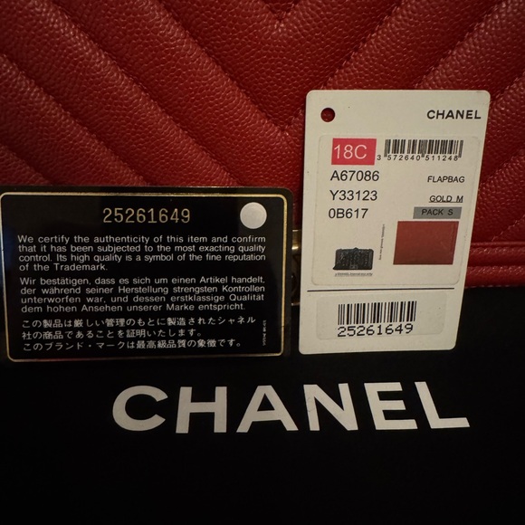 This is an authentic CHANEL Caviar Chevron Quilted Medium Boy Flap in Red - Picture 5 of 9